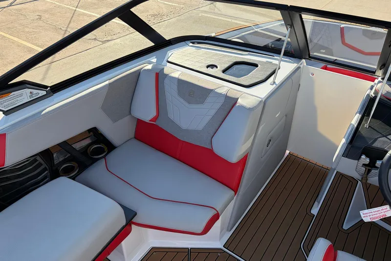 Slide: The Image of Interior of 2021 Nautique Super Air Nautique G23 boat with red and gray seating. - 23