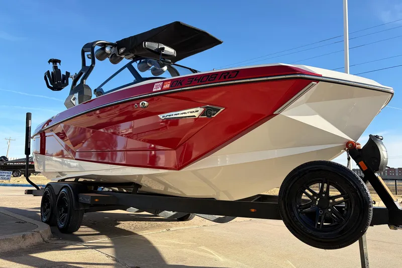 Slide: The Image of 2021 Nautique Super Air Nautique G23 boat in red and white on a trailer. - 3