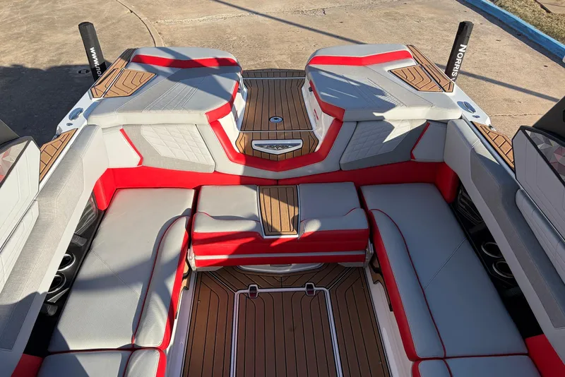 Slide: The Image of 2021 Nautique Super Air Nautique G23 interior with red and gray seating, teak flooring. - 35