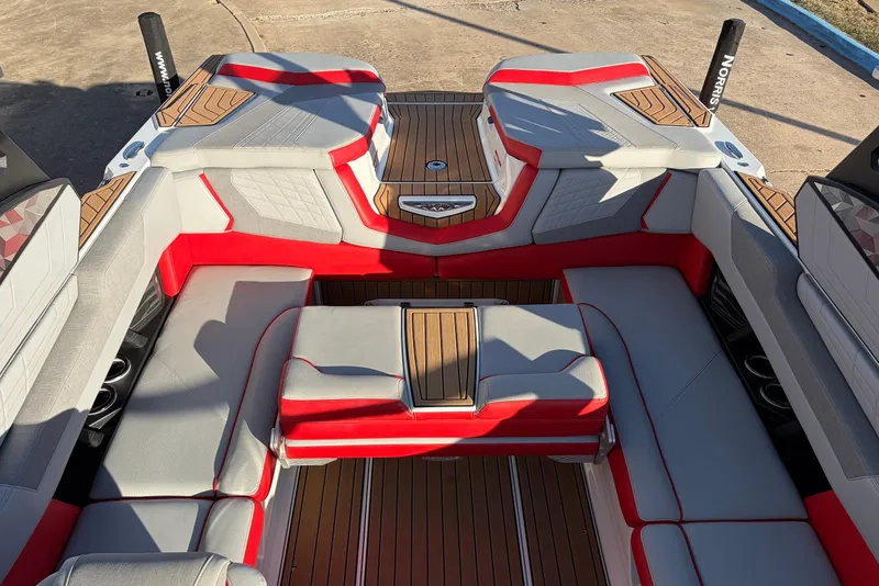 Slide: The Image of 2021 Nautique Super Air Nautique G23 interior with red and gray seating, teak flooring. - 36