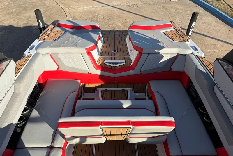 Slide: The Image of 2021 Nautique Super Air Nautique G23 interior with red and gray seating, teak flooring. - 37