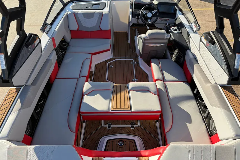 Slide: The Image of 2021 Nautique Super Air Nautique G23 interior with red and gray seating, wooden flooring. - 39