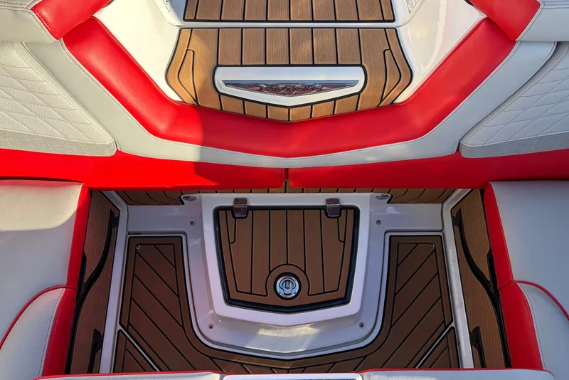 Slide: The Image of 2021 Nautique Super Air Nautique G23 interior with red and white seating, teak flooring. - 40