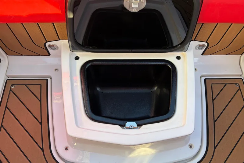 Slide: The Image of 2021 Nautique Super Air Nautique G23 storage compartment with teak flooring and red accents. - 41
