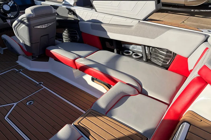 Slide: The Image of 2021 Nautique Super Air Nautique G23 interior with red and gray seating, teak flooring. - 42