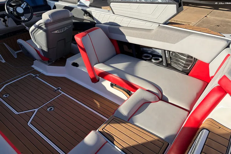 Slide: The Image of 2021 Nautique Super Air Nautique G23 interior with red and gray seating, wooden flooring. - 45