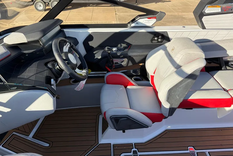 Slide: The Image of 2021 Nautique Super Air Nautique G23 interior with modern steering and seating. - 47