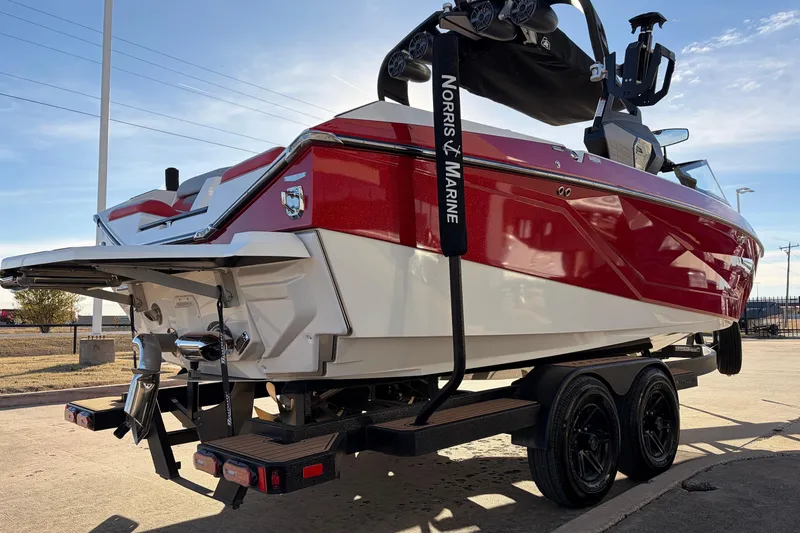 Slide: The Image of 2021 Nautique Super Air Nautique G23 boat on trailer, red and white design. - 5