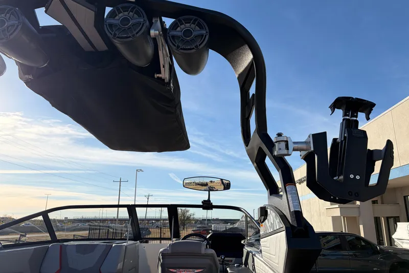 Slide: The Image of 2021 Nautique Super Air Nautique G23 boat with speakers and wakeboard tower under clear sky. - 52