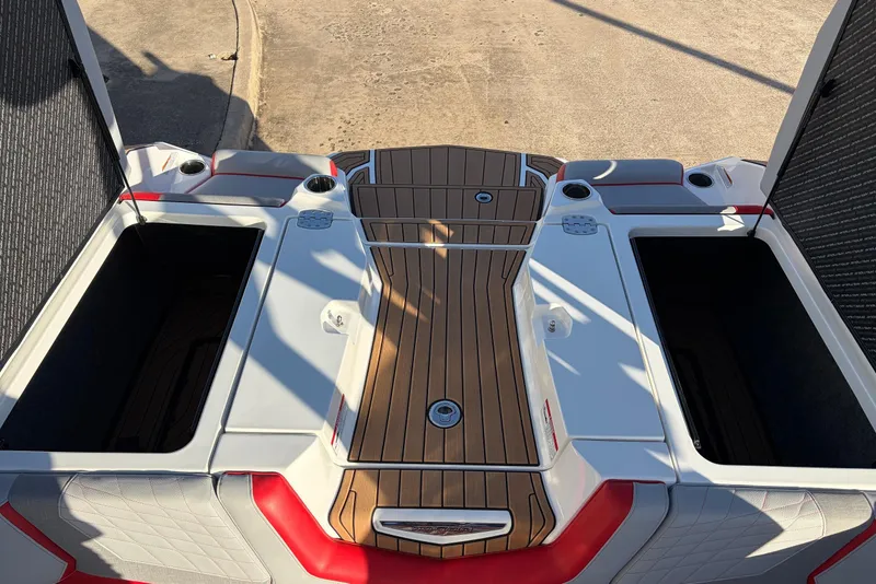 Slide: The Image of 2021 Nautique Super Air Nautique G23 boat deck with open storage compartments. - 56