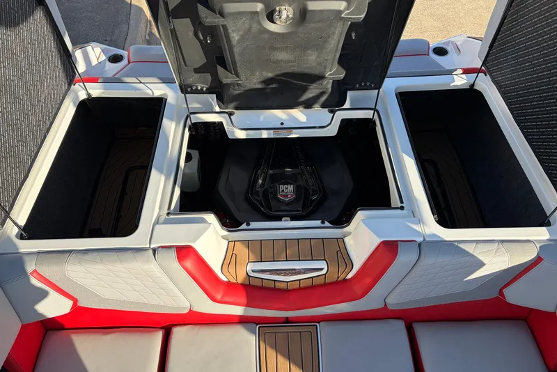 Slide: The Image of 2021 Nautique Super Air Nautique G23 engine compartment with open storage hatches. - 58