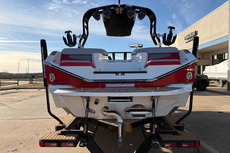 Slide: The Image of 2021 Nautique Super Air Nautique G23 boat rear view, red and white design, on trailer. - 6