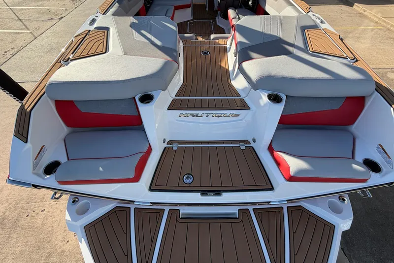 Slide: The Image of 2021 Nautique Super Air Nautique G23 boat interior with cushioned seating and wood accents. - 62