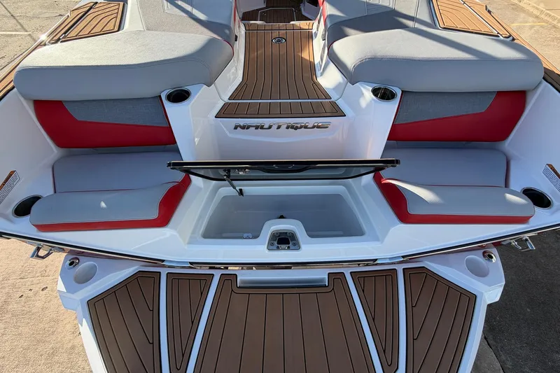 Slide: The Image of 2021 Nautique Super Air Nautique G23 boat interior with gray and red seating. - 63