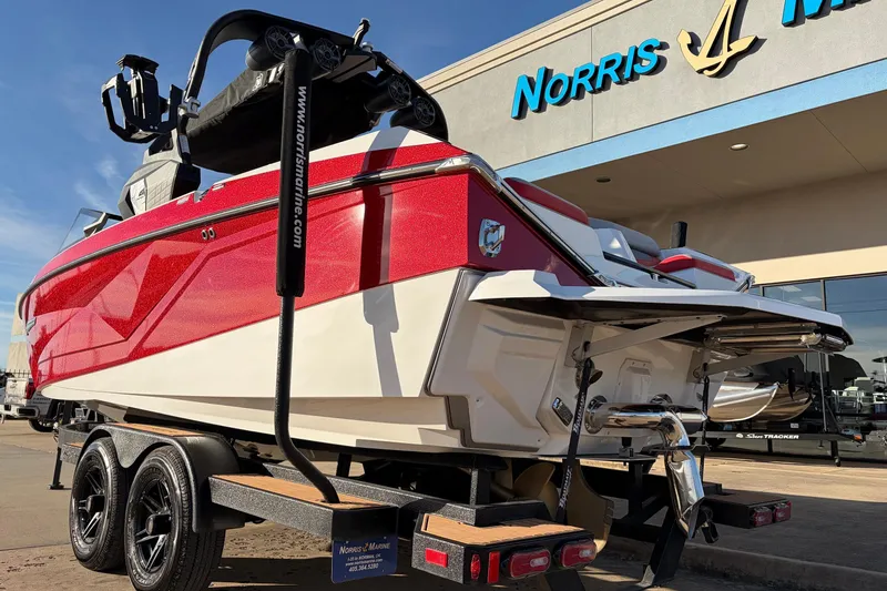 Slide: The Image of 2021 Nautique Super Air Nautique G23 boat in red, displayed at Norris Marine dealership. - 7