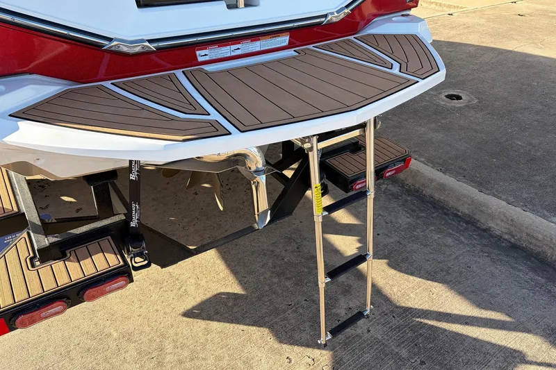 Slide: The Image of 2021 Nautique Super Air Nautique G23 swim platform with ladder, showcasing teak-style decking. - 8