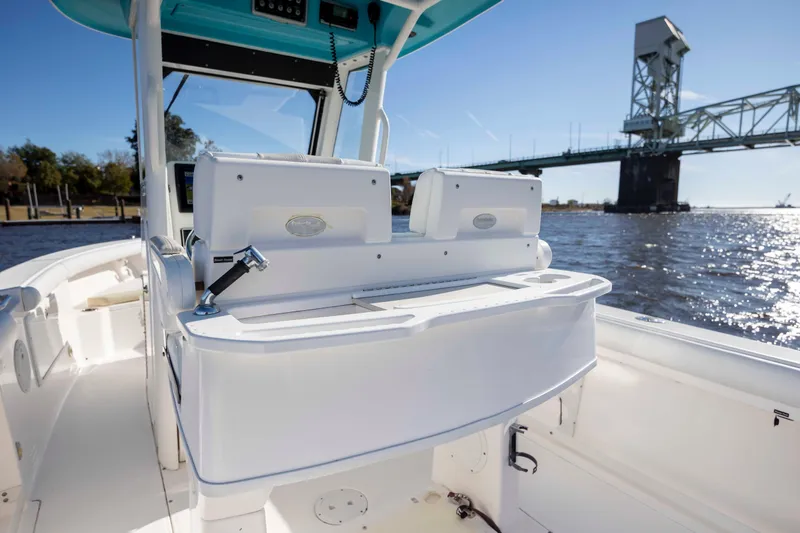 Slide: The Image of 2015 Everglades 255 Center Console boat on water near a bridge, sunny day. - 14