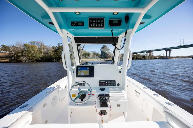 Slide: The Image of 2015 Everglades 255 Center Console boat on water, featuring modern navigation equipment. - 17