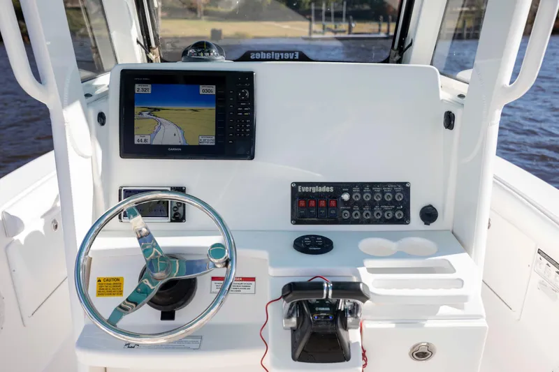 Slide: The Image of 2015 Everglades 255 Center Console boat dashboard with navigation system and controls. - 18