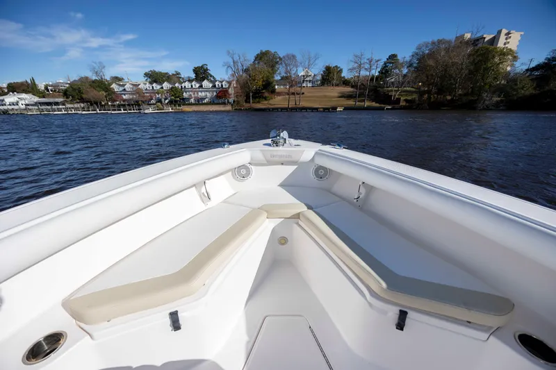 Slide: The Image of 2015 Everglades 255 Center Console boat on a scenic river with houses in the background. - 22