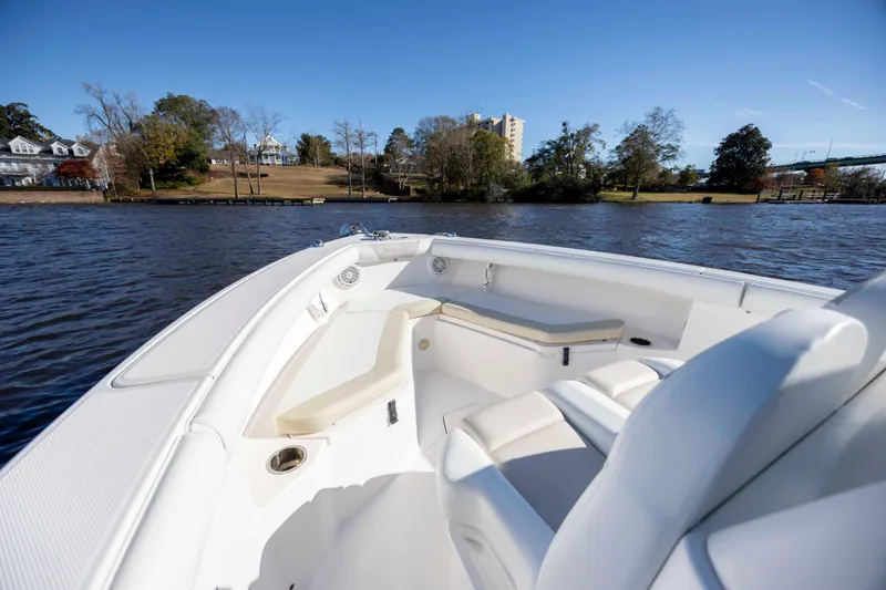 Slide: The Image of 2015 Everglades 255 Center Console boat on a scenic river with clear blue sky. - 23
