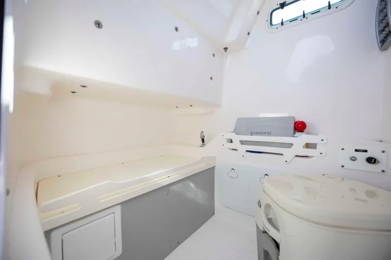 Slide: The Image of Interior of 2015 Everglades 255 Center Console boat, featuring storage and seating area. - 26