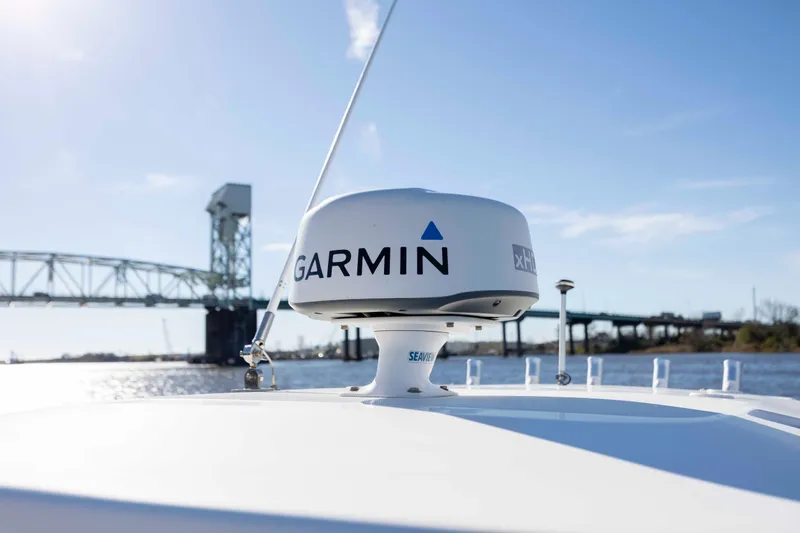 Slide: The Image of 2015 Everglades 255 Center Console with Garmin radar, bridge in background. - 27