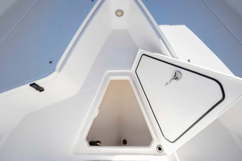 Slide: The Image of 2015 Everglades 255 Center Console boat storage compartment with open hatch. - 32