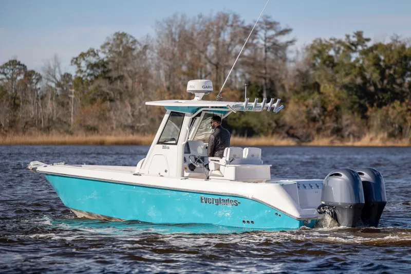 Slide: The Image of 2015 Everglades 255 Center Console boat cruising on a scenic waterway. - 4
