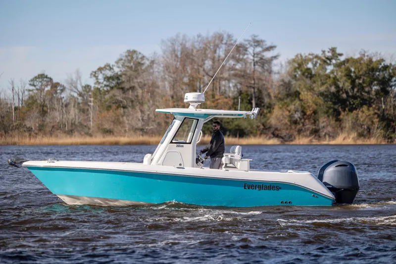 Slide: The Image of 2015 Everglades 255 Center Console boat cruising on a scenic waterway. - 5
