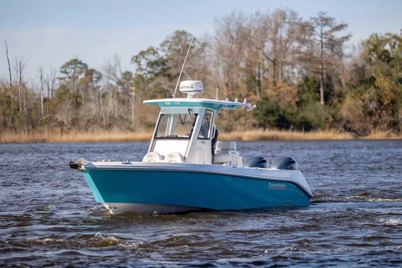 Slide: The Image of 2015 Everglades 255 Center Console boat cruising on a scenic waterway. - 6