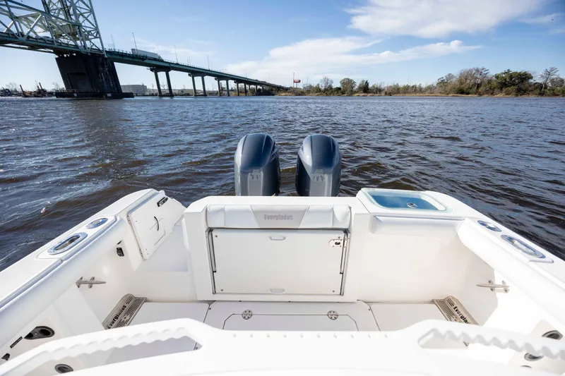 Slide: The Image of 2015 Everglades 255 Center Console boat on water near a bridge, featuring dual engines. - 8