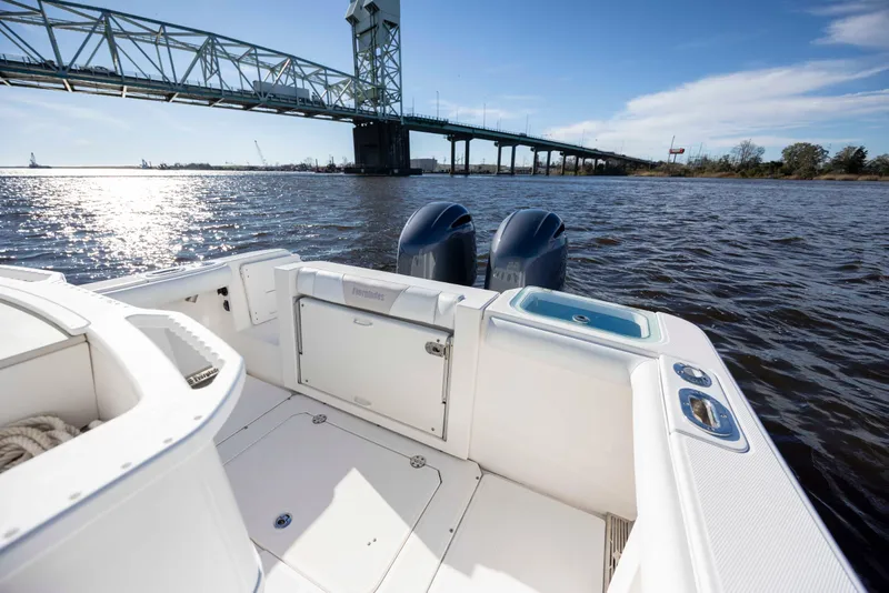 Slide: The Image of 2015 Everglades 255 Center Console boat on water near a bridge, sunny day. - 9