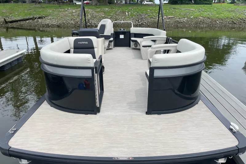 Slide: The Image of 2024 Harris Breeze 230 pontoon boat with spacious seating on a calm river. - 3