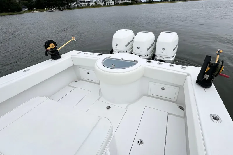 Slide: The Image of 2019 Onslow Bay 33 TE boat with triple Mercury engines on calm water. - 10