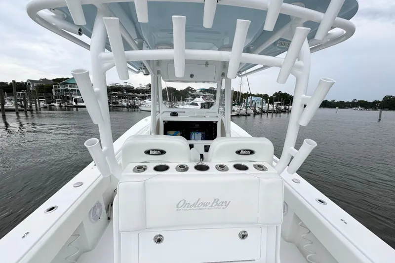 Slide: The Image of 2019 Onslow Bay 33 TE boat with rod holders, docked in a marina. - 11