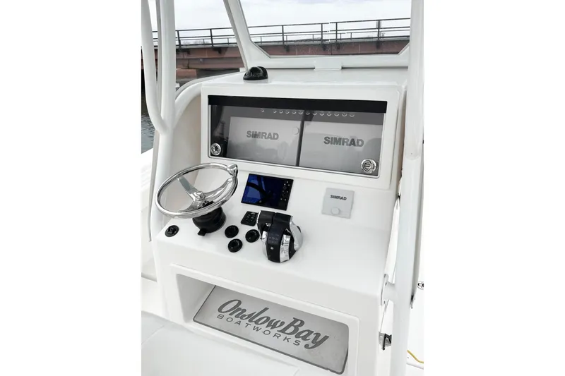 Slide: The Image of 2019 Onslow Bay 33 TE boat console with Simrad electronics and steering wheel. - 12
