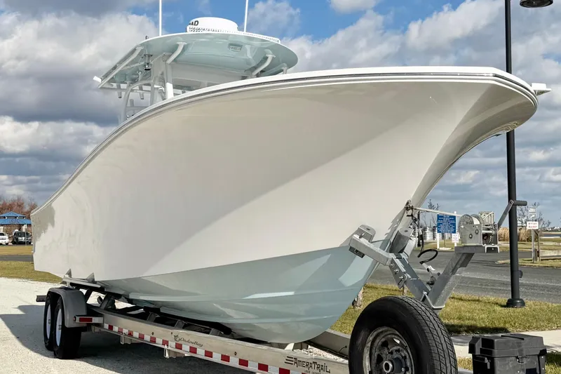 Slide: The Image of 2019 Onslow Bay 33 TE boat on trailer under cloudy sky. - 3