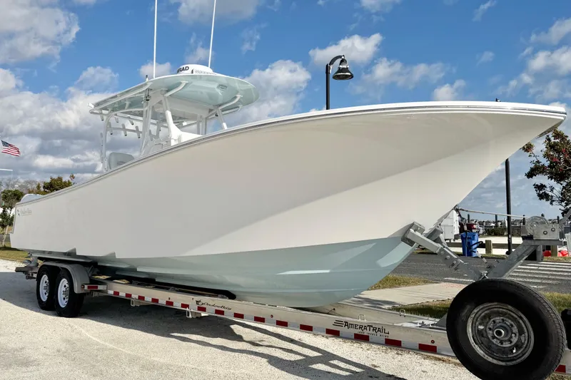 Slide: The Image of 2019 Onslow Bay 33 TE boat on trailer under blue sky. - 6