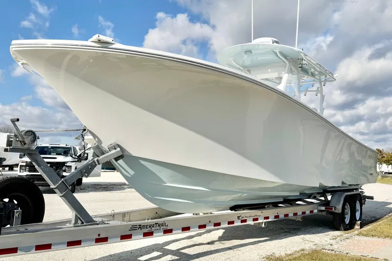 Slide: The Image of 2019 Onslow Bay 33 TE boat on trailer under blue sky. - 7