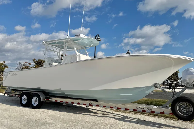 Slide: The Image of 2019 Onslow Bay 33 TE boat on trailer under blue sky. - 8