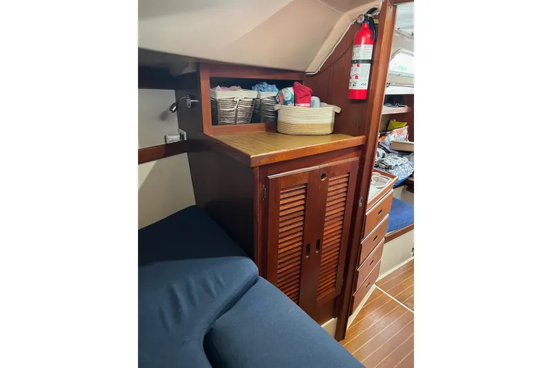 Slide: The Image of Interior of 1986 Catalina 36 MK1 sailboat with wooden cabinetry and storage baskets. - 10