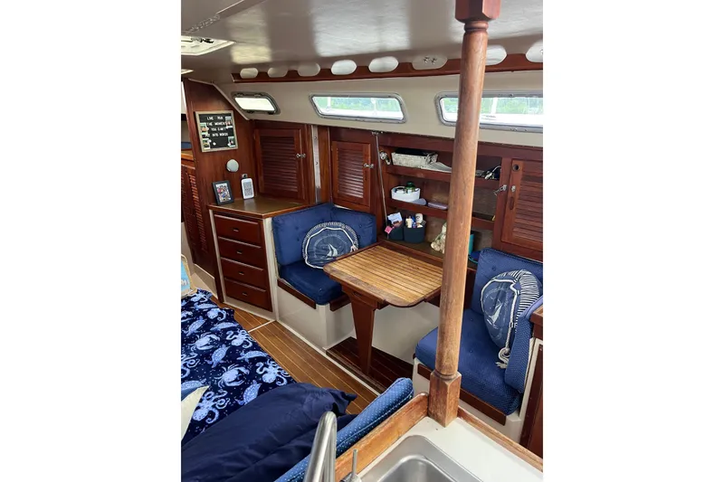 Slide: The Image of Interior of 1986 Catalina 36 MK1 sailboat with wooden furnishings and cozy seating area. - 13
