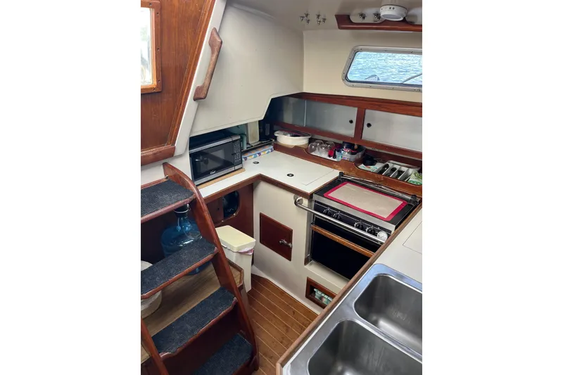 Slide: The Image of Interior of 1986 Catalina 36 MK1 sailboat galley with stove, sink, and storage. - 14