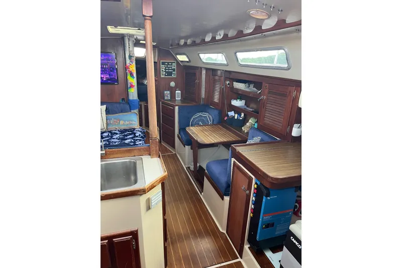 Slide: The Image of Interior of 1986 Catalina 36 MK1 sailboat with wooden furnishings and cozy seating. - 19