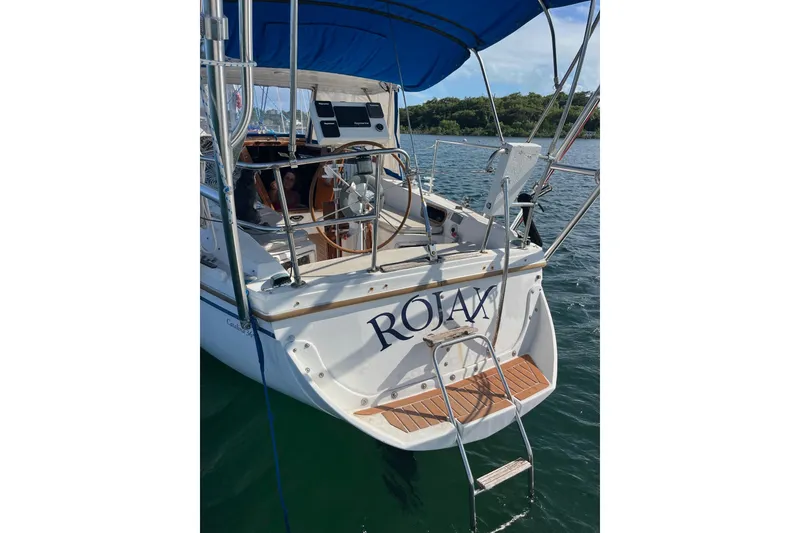 Slide: The Image of Catalina 36 MK1 sailboat, 1986 model, docked with blue canopy and swim ladder. - 3