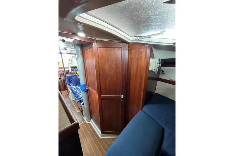 Slide: The Image of Interior of 1986 Catalina 36 MK1 sailboat with wooden cabinetry and cozy seating. - 7