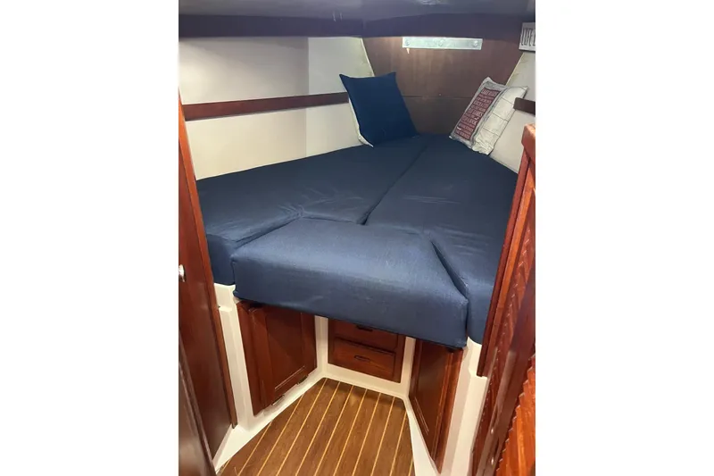 Slide: The Image of Cozy cabin interior of 1986 Catalina 36 MK1 sailboat with blue bedding and wooden accents. - 9