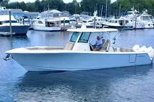 The Image of 2019 Sailfish 360 CC boat docked in marina with multiple yachts in background. - 0