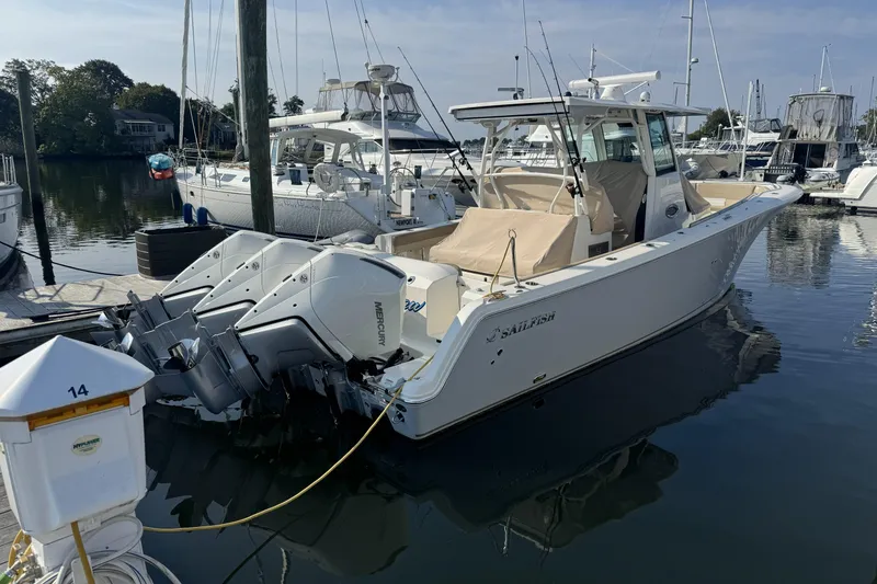 Slide: The Image of 2019 Sailfish 360 CC boat docked with triple Mercury outboard engines. - 10
